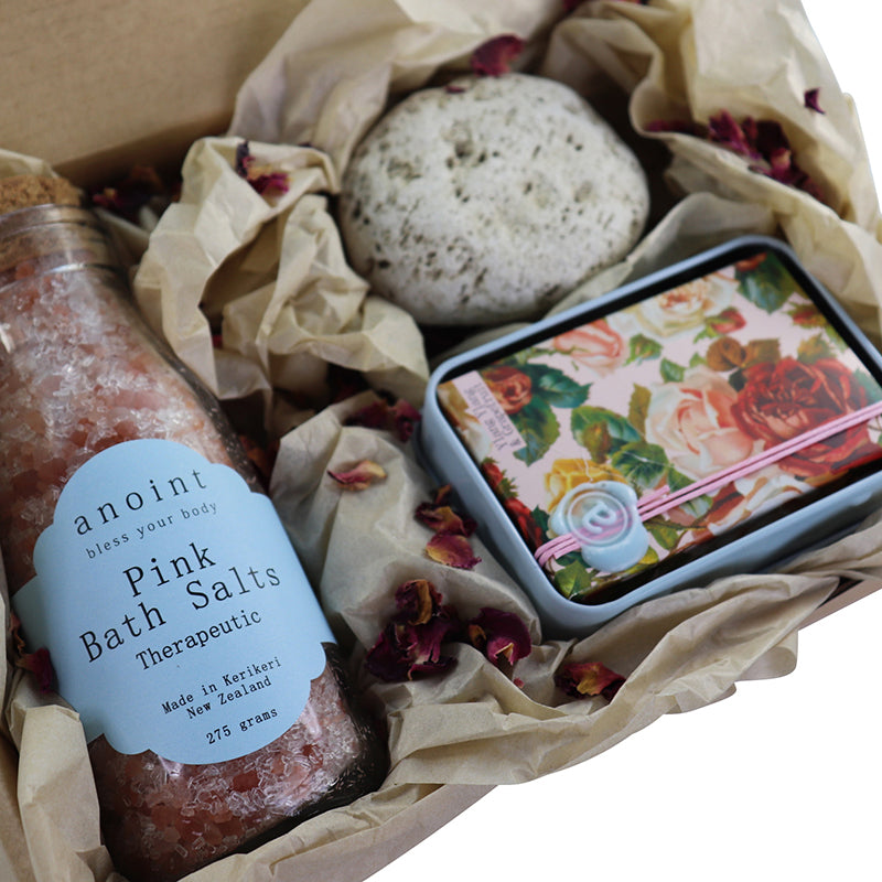 Foot spa gift box containing a bottle of pink bath salts, a body lotion bar and some pumice.